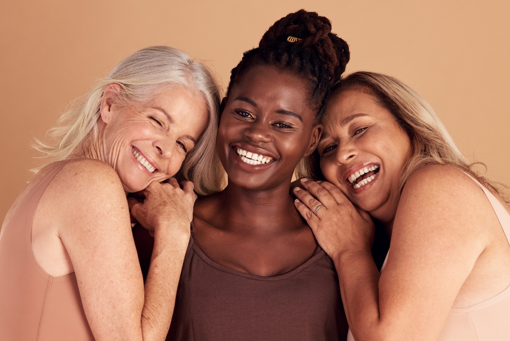Three women of different ages together, smiling