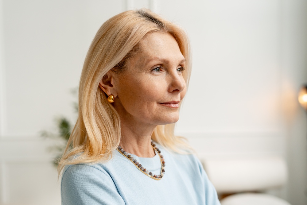 A woman in profile, looking calmly into the distance